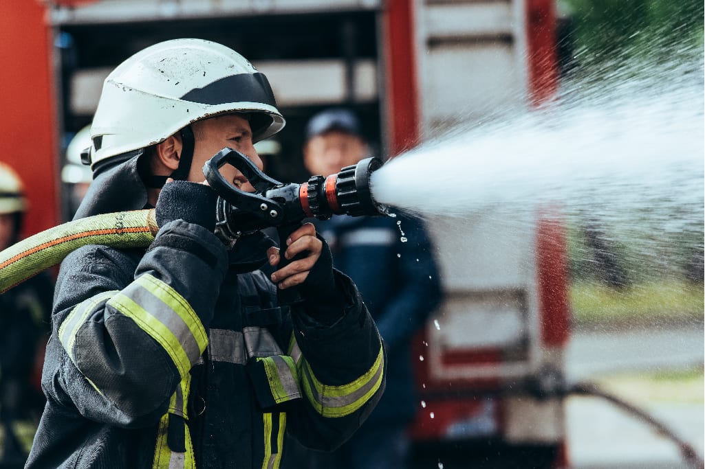 Firefighter using his hose.