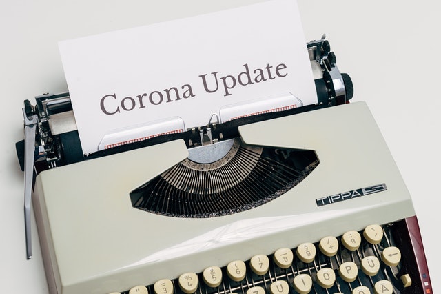 type writer with corona update on paper