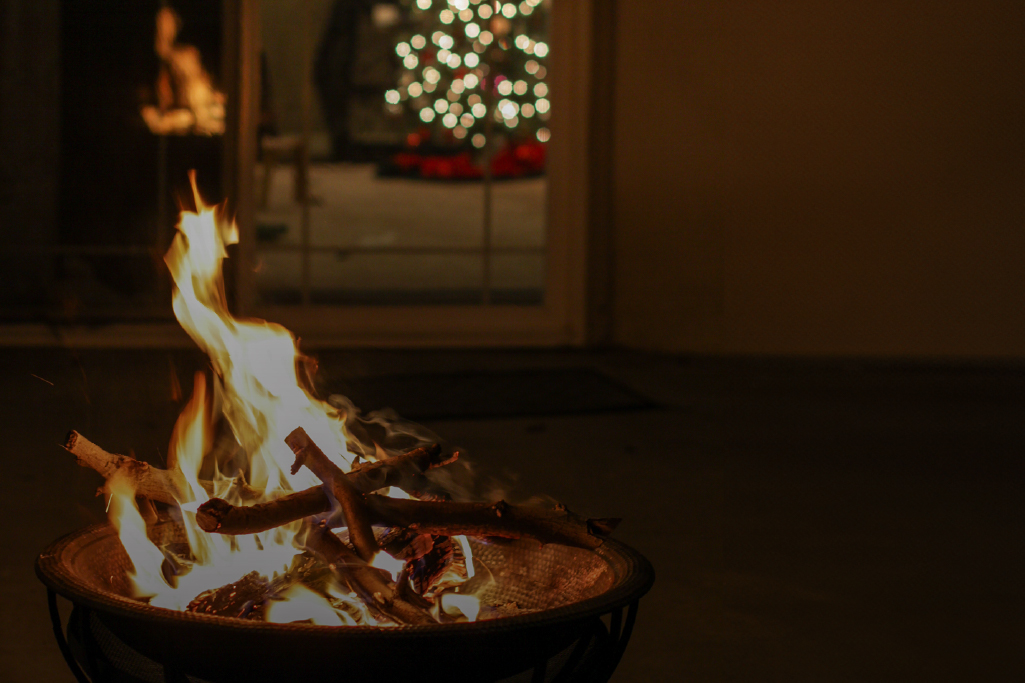 bonfire with a Christmas tree in the background.